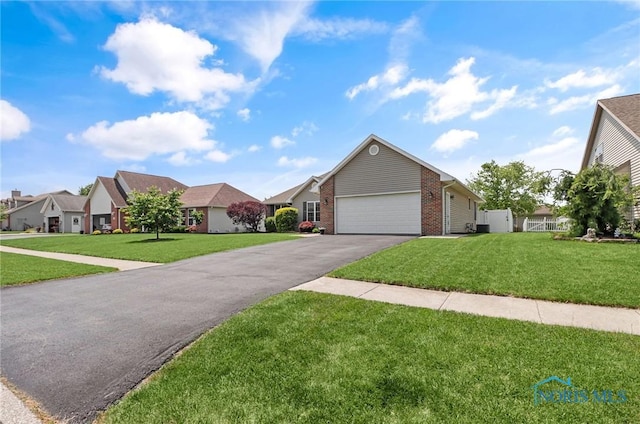 740 Tarra Oaks Dr, Findlay, OH 45840 - view of front facade with driveway, a front yard, brick siding, and a garage
