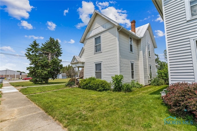 118 Allen Ave, Findlay, OH 45840 - view of side of property with a lawn and a chimney