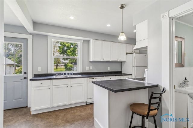 118 Allen Ave, Findlay, OH 45840 - kitchen featuring white appliances, dark countertops, white cabinetry, hanging light fixtures, and recessed lighting