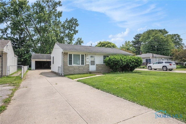 3913 Mcgregor Ln, Toledo, OH 43623 - view of front of home featuring stone siding, an outbuilding, and a garage