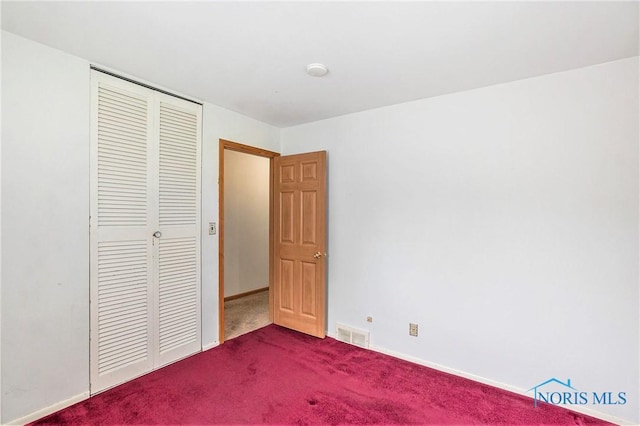 3913 Mcgregor Ln, Toledo, OH 43623 - unfurnished bedroom featuring a closet and dark colored carpet