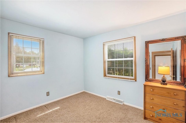 3913 Mcgregor Ln, Toledo, OH 43623 - unfurnished bedroom with baseboards and light carpet