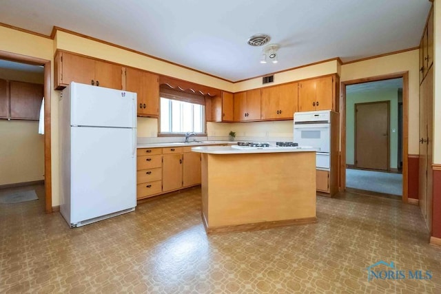 1527 Lockwood Rd, Findlay, OH 45840 - kitchen with white appliances, light countertops, crown molding, tile patterned floors, and a warming drawer
