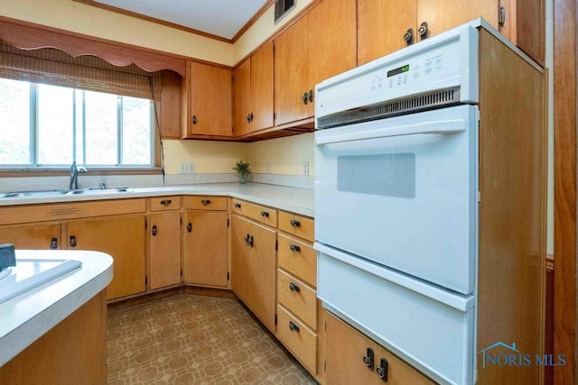 1527 Lockwood Rd, Findlay, OH 45840 - kitchen with white oven, light countertops, tile patterned floors, crown molding, and a warming drawer