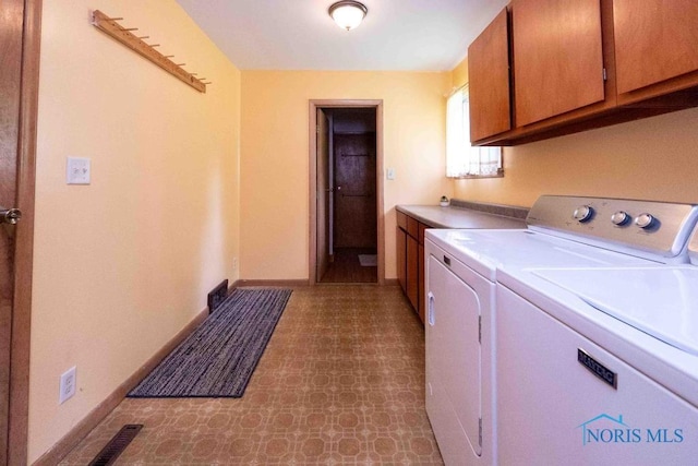 1527 Lockwood Rd, Findlay, OH 45840 - laundry area with cabinet space, washing machine and clothes dryer, and tile patterned floors
