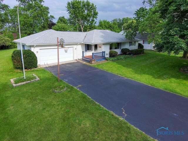 1527 Lockwood Rd, Findlay, OH 45840 - single story home featuring an attached garage, driveway, covered porch, and a front yard