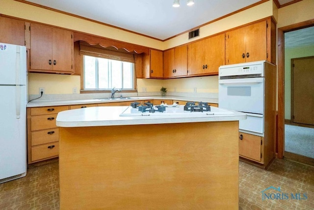 1527 Lockwood Rd, Findlay, OH 45840 - kitchen featuring white appliances, light countertops, ornamental molding, brown cabinets, and a kitchen island