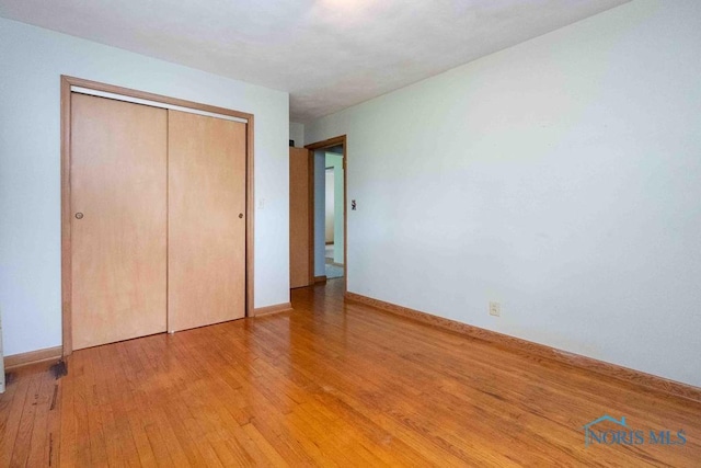 1527 Lockwood Rd, Findlay, OH 45840 - unfurnished bedroom with light wood-style flooring and a closet