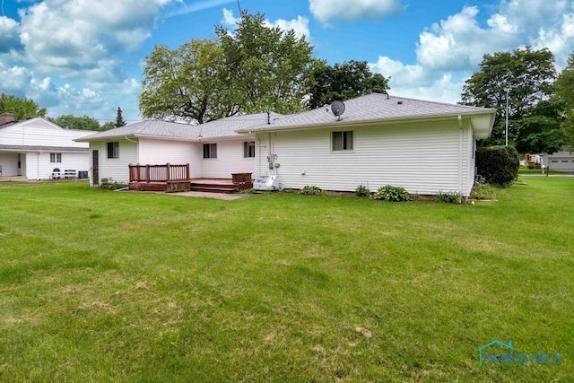 1527 Lockwood Rd, Findlay, OH 45840 - rear view of house with a wooden deck and a lawn