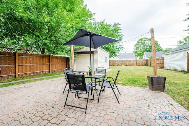 3714 Kershaw Ave, Toledo, OH 43613 - fenced backyard featuring outdoor dining area, an outbuilding, a patio area, and a garage
