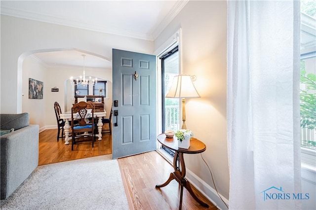 3714 Kershaw Ave, Toledo, OH 43613 - foyer featuring arched walkways, ornamental molding, healthy amount of natural light, and a chandelier