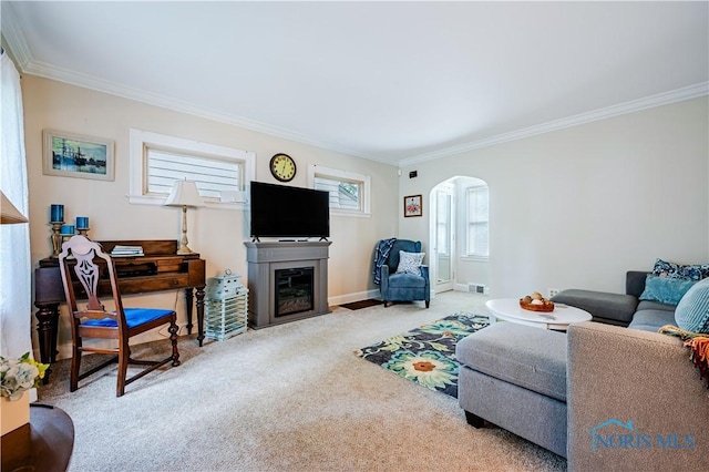 3714 Kershaw Ave, Toledo, OH 43613 - living room with carpet, arched walkways, crown molding, and a fireplace with flush hearth