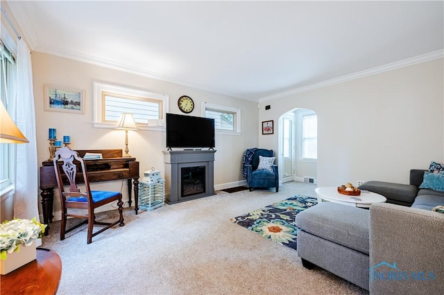 3714 Kershaw Ave, Toledo, OH 43613 - carpeted living room with arched walkways, crown molding, and a glass covered fireplace