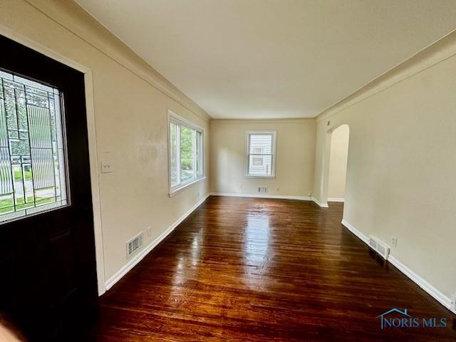 3748 Orono Dr, Toledo, OH 43614 - spare room with arched walkways and wood finished floors