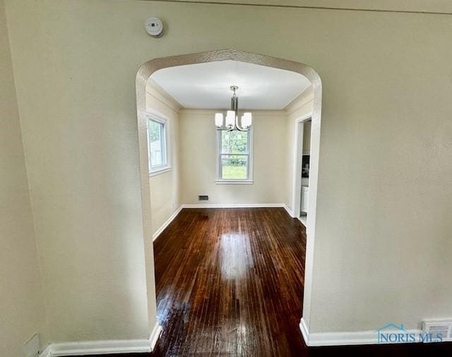 3748 Orono Dr, Toledo, OH 43614 - unfurnished dining area with a chandelier, hardwood / wood-style flooring, and arched walkways