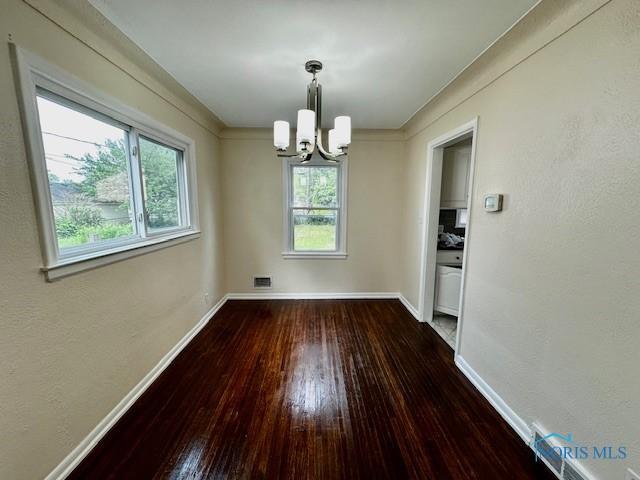 3748 Orono Dr, Toledo, OH 43614 - unfurnished dining area with a chandelier and hardwood / wood-style flooring