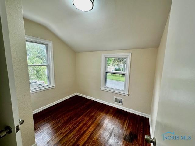 3748 Orono Dr, Toledo, OH 43614 - unfurnished room featuring vaulted ceiling and dark wood-type flooring