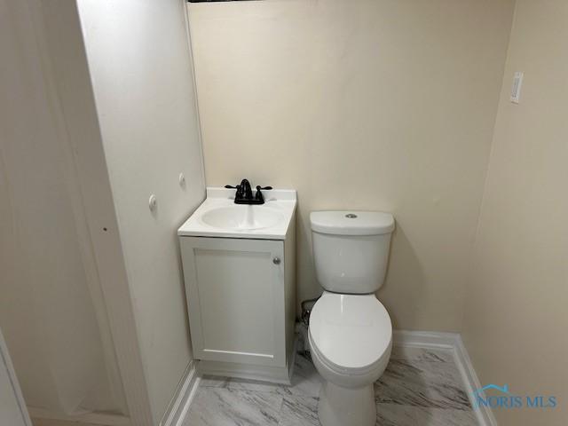 3748 Orono Dr, Toledo, OH 43614 - half bathroom featuring marble look tiles and vanity