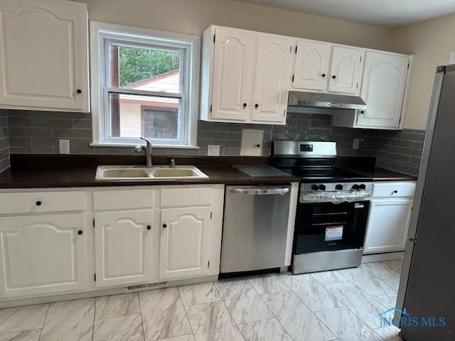 3748 Orono Dr, Toledo, OH 43614 - kitchen featuring stainless steel appliances, under cabinet range hood, dark countertops, and white cabinets