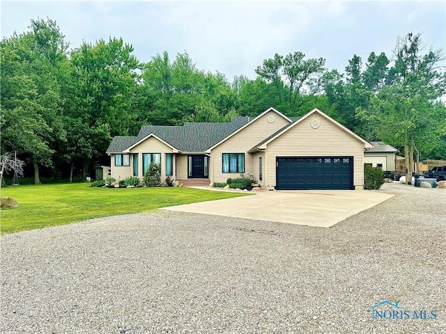 3391 Rd 144, Antwerp, OH 45813 - ranch-style home featuring a garage, concrete driveway, and a front yard
