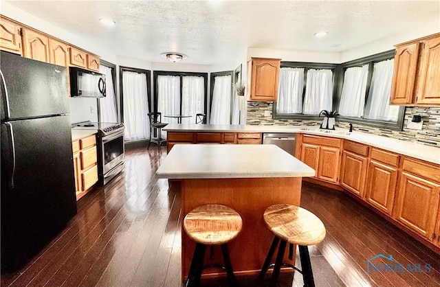 3391 Rd 144, Antwerp, OH 45813 - kitchen with black appliances, dark wood-style flooring, backsplash, light countertops, and recessed lighting