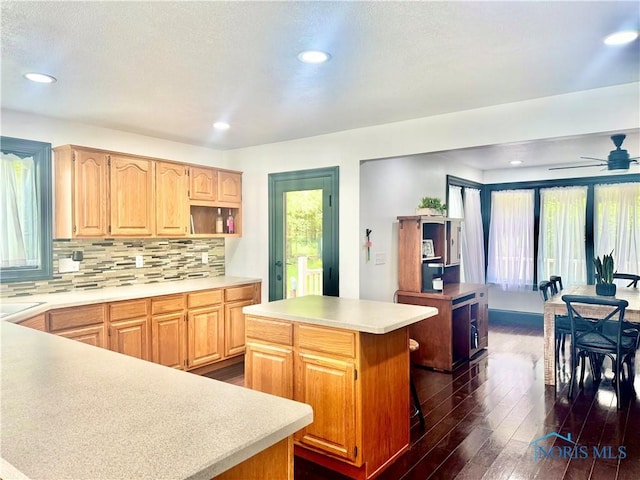 3391 Rd 144, Antwerp, OH 45813 - kitchen featuring dark wood-type flooring, a center island, tasteful backsplash, light countertops, and a ceiling fan