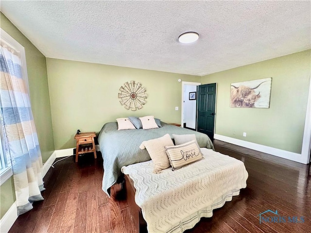 3391 Rd 144, Antwerp, OH 45813 - bedroom featuring wood-type flooring, multiple windows, and a textured ceiling