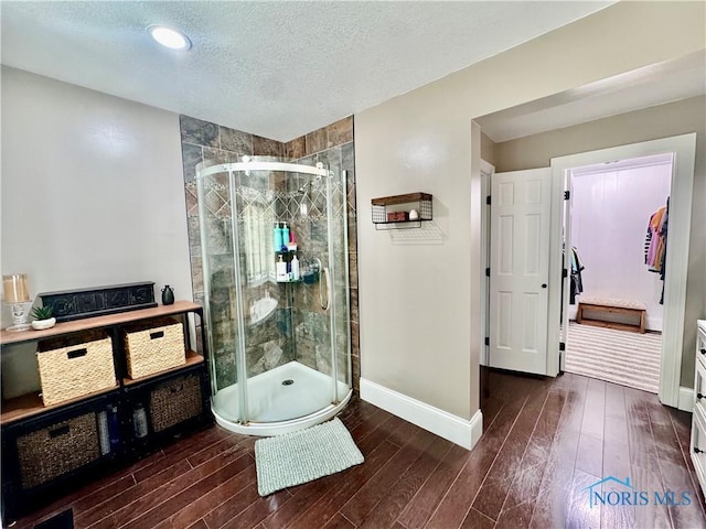3391 Rd 144, Antwerp, OH 45813 - bathroom with wood finished floors, a stall shower, and a textured ceiling