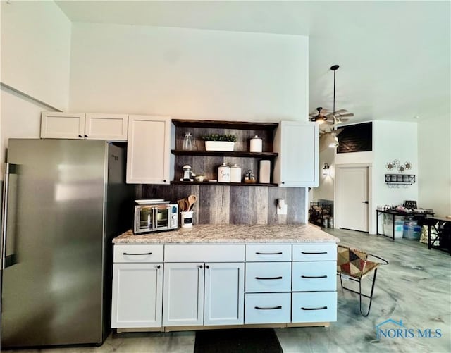3391 Rd 144, Antwerp, OH 45813 - kitchen with freestanding refrigerator, open shelves, white cabinetry, light stone counters, and finished concrete flooring