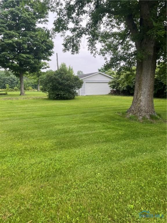 6432 State Route 576, Bryan, OH 43506 - view of grassy yard with a garage