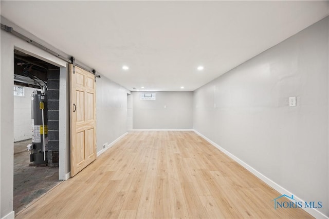 2421 106th Rd, Toledo, OH 43611 - basement with a barn door, gas water heater, light wood-type flooring, and recessed lighting