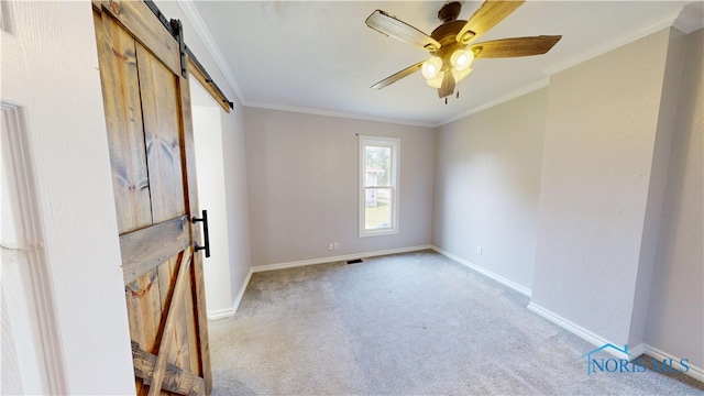 628 W Maple St, Clyde, OH 43410 - unfurnished room featuring a barn door, light colored carpet, crown molding, and a ceiling fan
