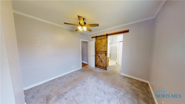 628 W Maple St, Clyde, OH 43410 - unfurnished bedroom with a barn door, light colored carpet, crown molding, a ceiling fan, and ensuite bathroom