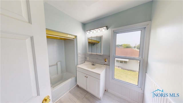 628 W Maple St, Clyde, OH 43410 - full bathroom with vanity, plenty of natural light, and a wainscoted wall