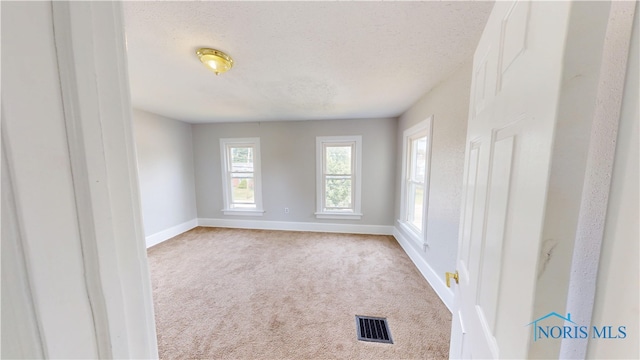 628 W Maple St, Clyde, OH 43410 - carpeted spare room featuring baseboards and a textured ceiling