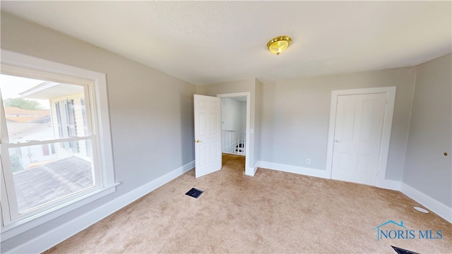 628 W Maple St, Clyde, OH 43410 - unfurnished bedroom featuring light colored carpet and a closet
