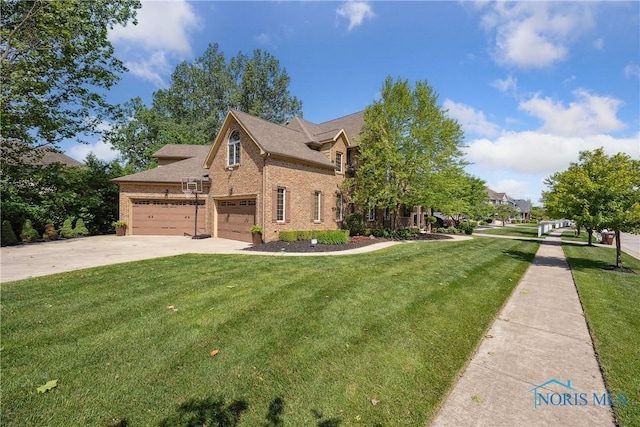 4811 Yosemite Pkwy, Sylvania, OH 43560 - view of front of house featuring brick siding, concrete driveway, a front lawn, and an attached garage