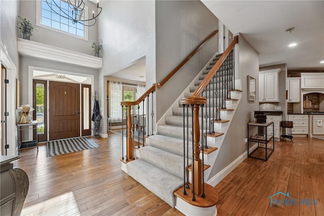 4811 Yosemite Pkwy, Sylvania, OH 43560 - foyer featuring healthy amount of natural light, light wood-style floors, stairway, a high ceiling, and recessed lighting