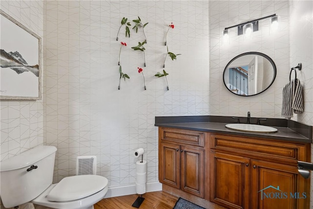 4811 Yosemite Pkwy, Sylvania, OH 43560 - half bathroom featuring vanity, tile walls, and wood finished floors