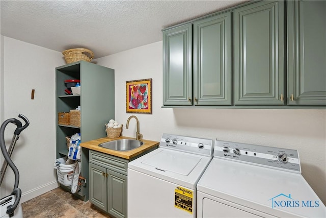 4811 Yosemite Pkwy, Sylvania, OH 43560 - washroom with cabinet space, washing machine and dryer, and a textured ceiling