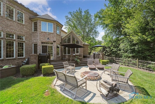 4811 Yosemite Pkwy, Sylvania, OH 43560 - view of patio / terrace featuring a fire pit and a wooden deck