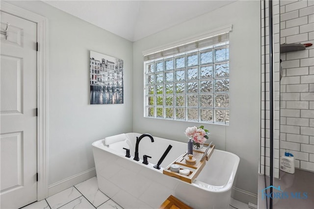 4811 Yosemite Pkwy, Sylvania, OH 43560 - bathroom featuring a freestanding tub and marble look tile flooring