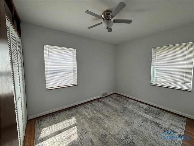 2914 118th St, Toledo, OH 43611 - unfurnished bedroom with a closet, wood finished floors, and a ceiling fan