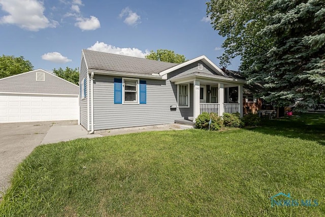 1040 Richland St, Maumee, OH 43537 - view of front of property featuring a porch, a detached garage, a front yard, an outbuilding, and roof with shingles