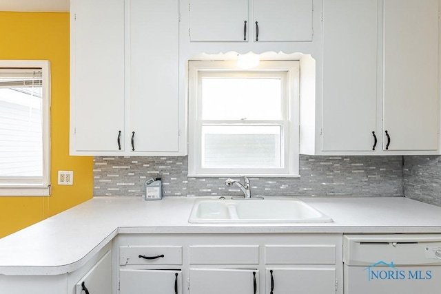 1040 Richland St, Maumee, OH 43537 - kitchen featuring dishwasher, light countertops, white cabinetry, and tasteful backsplash