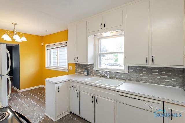 1040 Richland St, Maumee, OH 43537 - kitchen featuring white appliances, backsplash, light countertops, a chandelier, and white cabinets