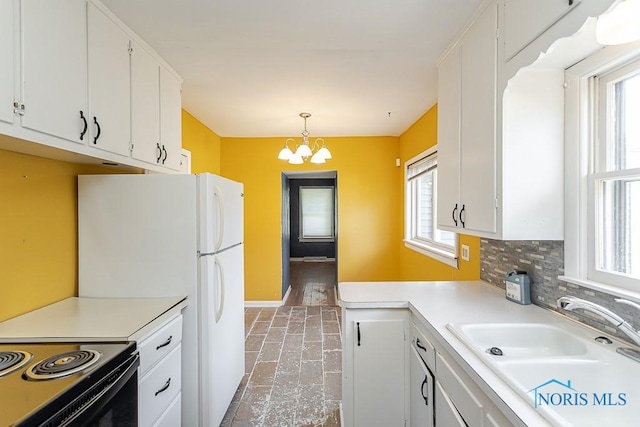 1040 Richland St, Maumee, OH 43537 - kitchen with healthy amount of natural light, white cabinets, and light countertops
