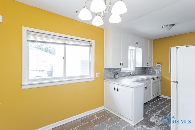 1040 Richland St, Maumee, OH 43537 - kitchen featuring white appliances, plenty of natural light, light countertops, and a chandelier