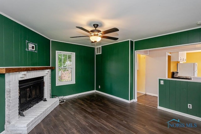 1040 Richland St, Maumee, OH 43537 - unfurnished living room featuring ornamental molding, a ceiling fan, a fireplace, and wood finished floors