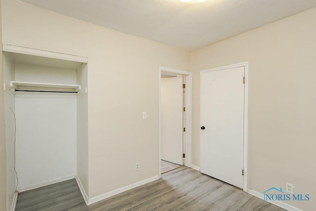 1040 Richland St, Maumee, OH 43537 - unfurnished bedroom featuring wood finished floors and a closet